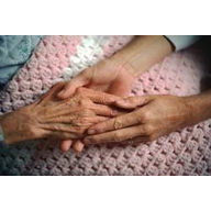 elderly resident holding hands with young care worker